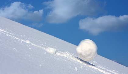 Snowball rolling down hill.